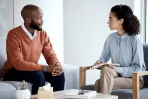 A patient discussing his symptoms with his therapist.