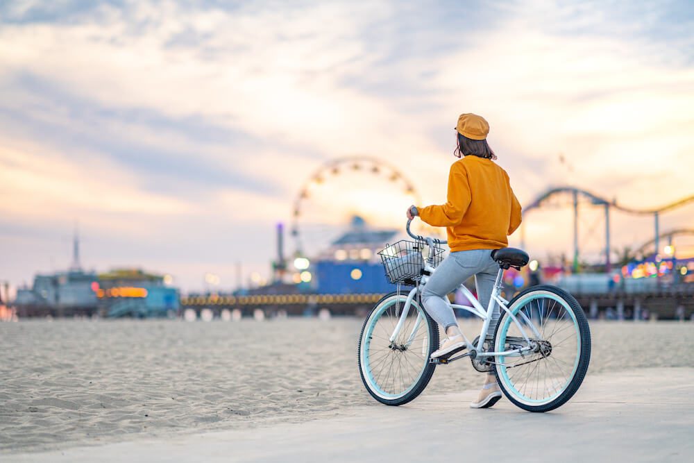 woman with bipolar disorder riding her bike in santa monica at sunset
