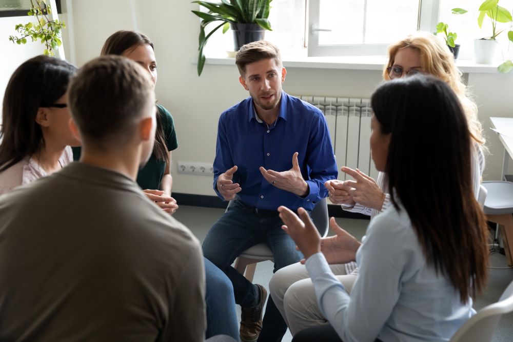A group of people discussing their day to day routines during a group therapy session.