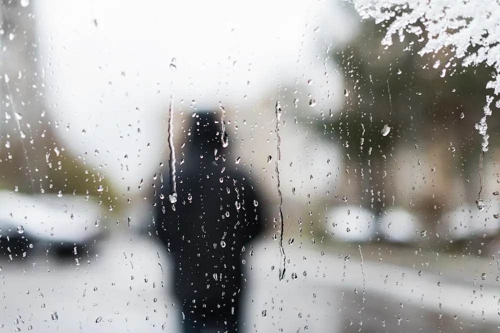 man walking in the rain during a depressive episode from his seasonal depression