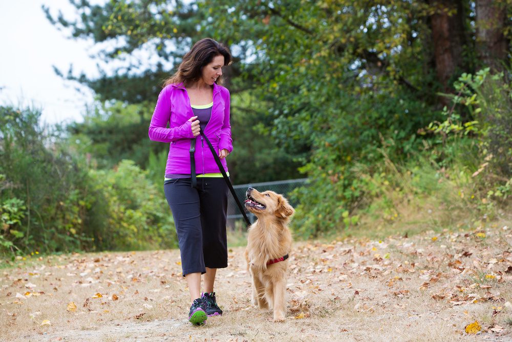 woman taking a mental health walk with her dog in her home