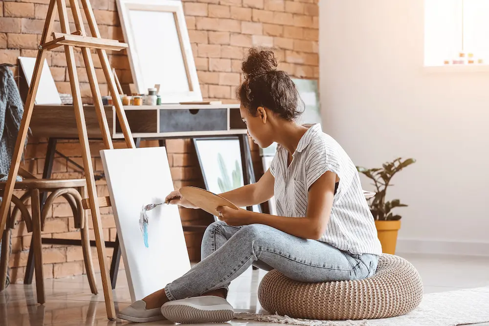 woman with mental health disorders painting to escape